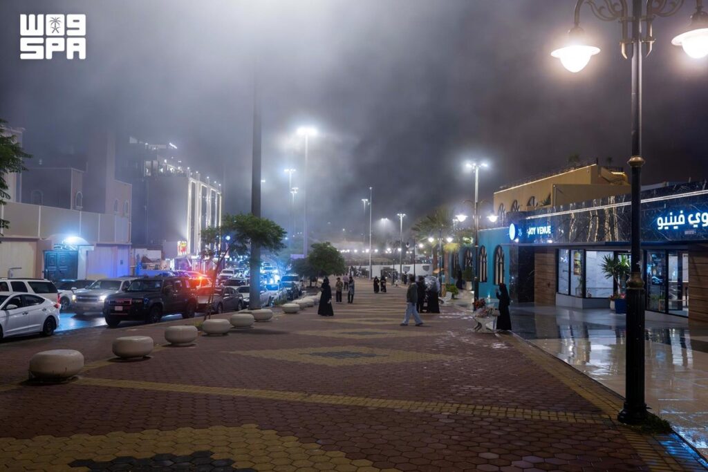 زوار ممشى الضباب في أبها وسط الضباب ليلًا