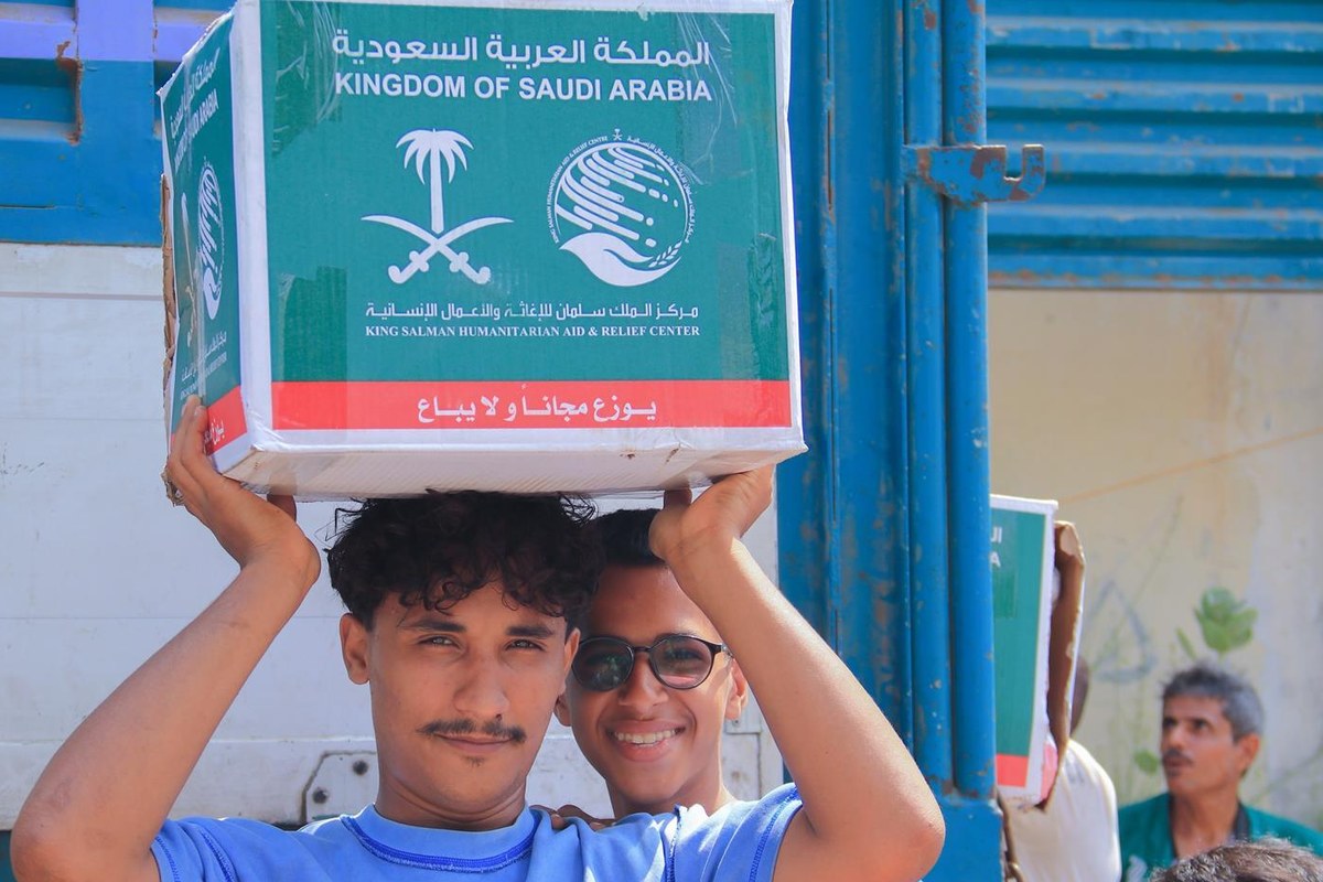 مستفيد يحمل سلة غذائية من مركز الملك سلمان للإغاثة في عدن